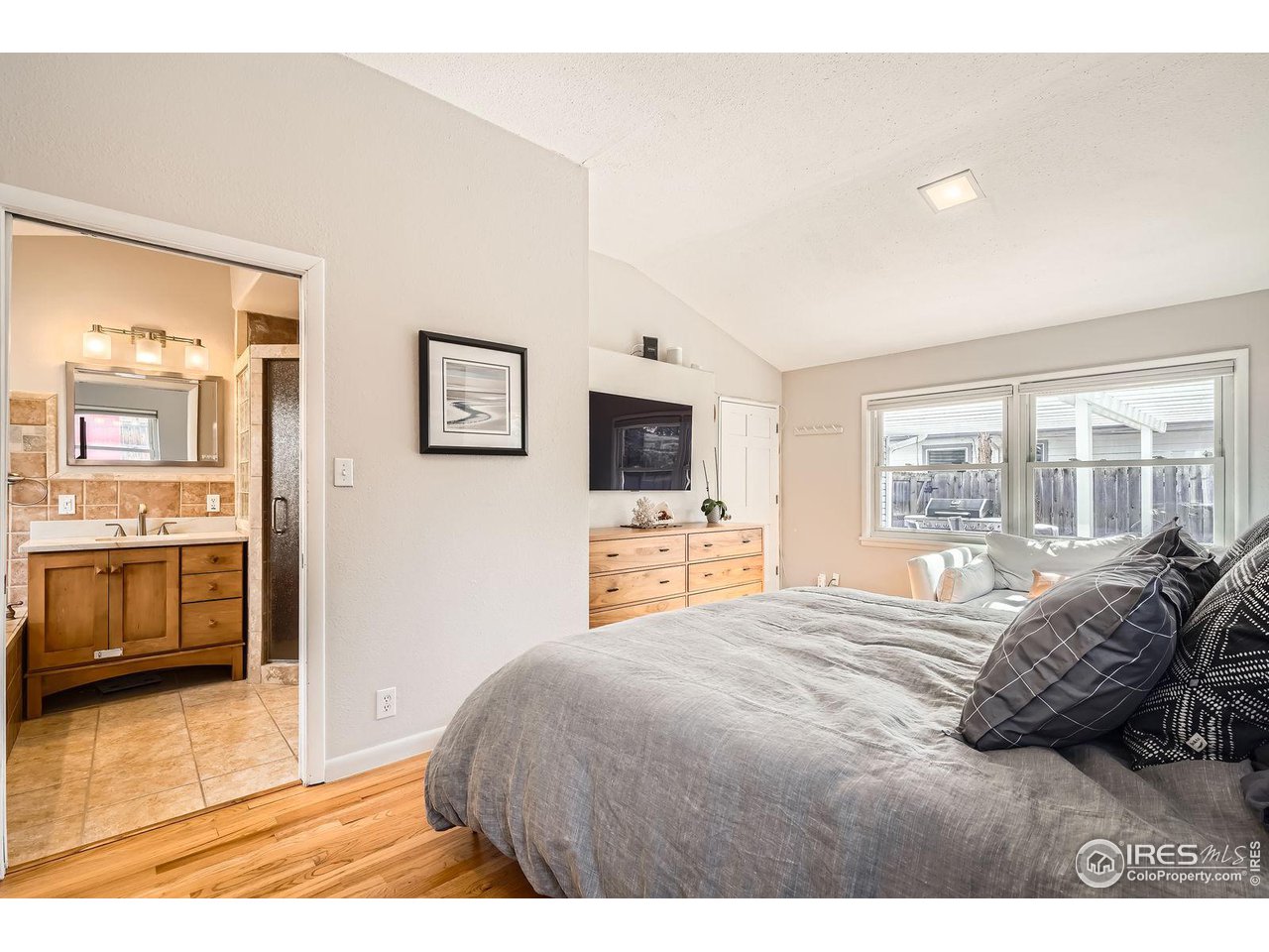419 22nd Street Boulder, CO 80302 - Photo 14 of 38 a bedroom with a bed and a television