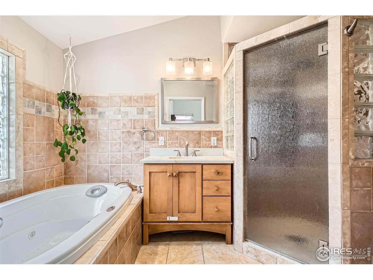 419 22nd Street Boulder, CO 80302 - Photo 15 of 38 a bathroom with a granite countertop bathtub a sink and a shower