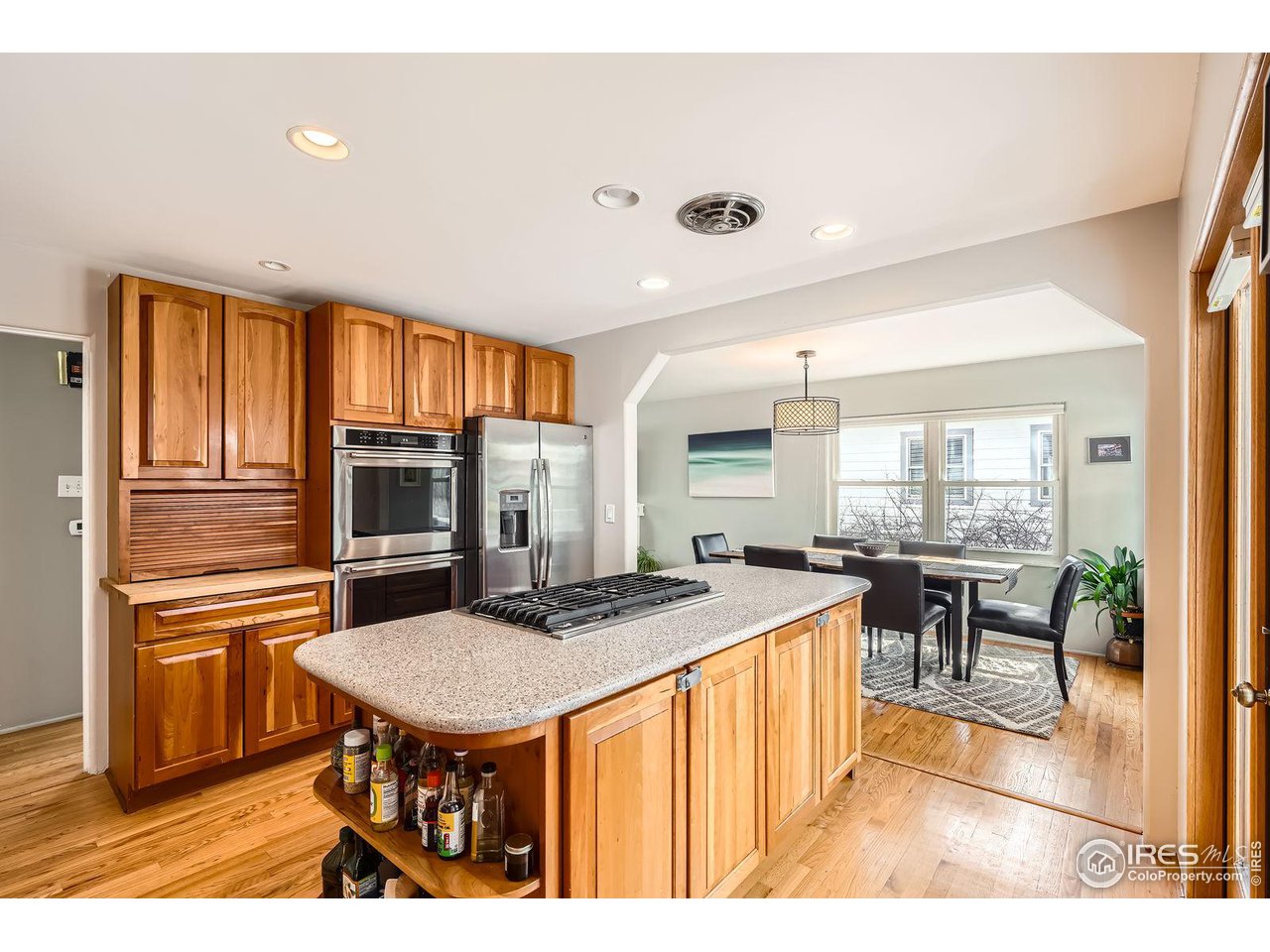 419 22nd Street Boulder, CO 80302 - Photo 9 of 38 a kitchen with stainless steel appliances granite countertop a kitchen island a stove a table and chairs