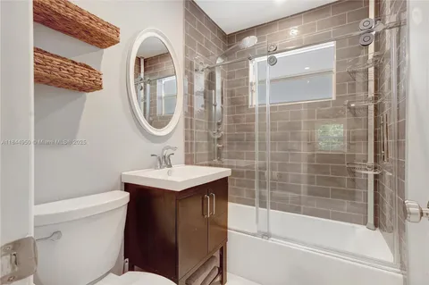 a white toilet sitting next to a bathroom sink