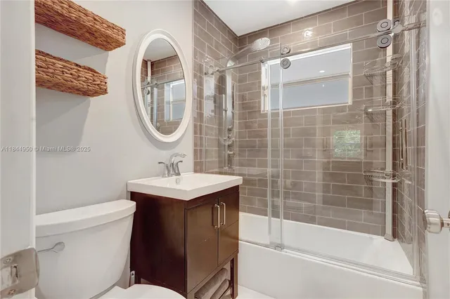 a white toilet sitting next to a bathroom sink