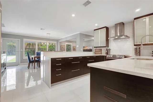 a large kitchen with a table and chairs