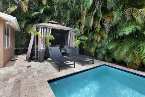 a view of a patio with table and chairs and potted plants