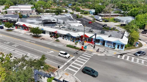 a view of a white house with a chairs in a patio