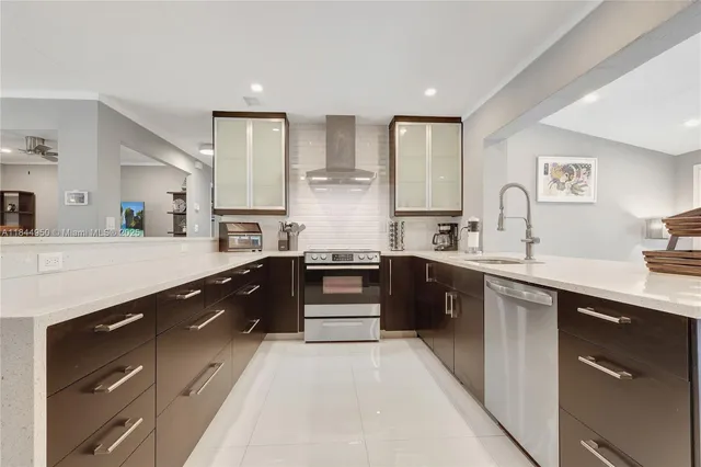 a large kitchen with stainless steel appliances kitchen island granite countertop a sink dishwasher a stove and white cabinets