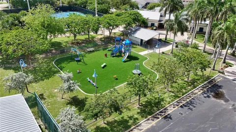 a view of a tennis ground with sitting area