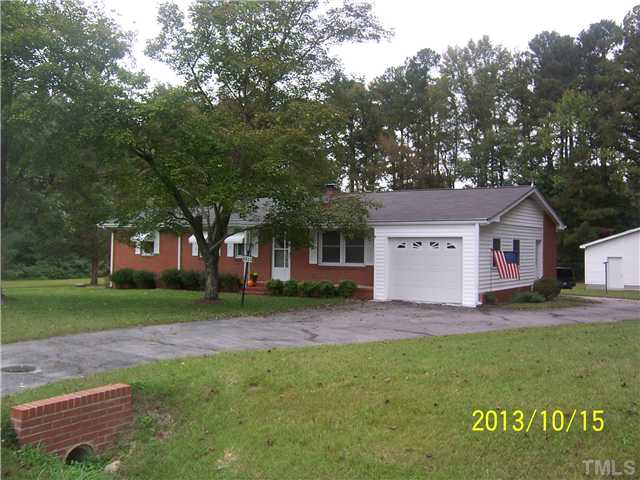 4313 Old Milburnie Road Raleigh, NC 27616 - Photo 1 of 15 a front view of a house with a yard and garage