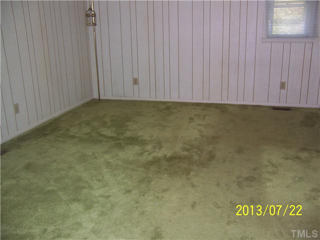 4313 Old Milburnie Road Raleigh, NC 27616 - Photo 7 of 15 an empty room with a wooden door