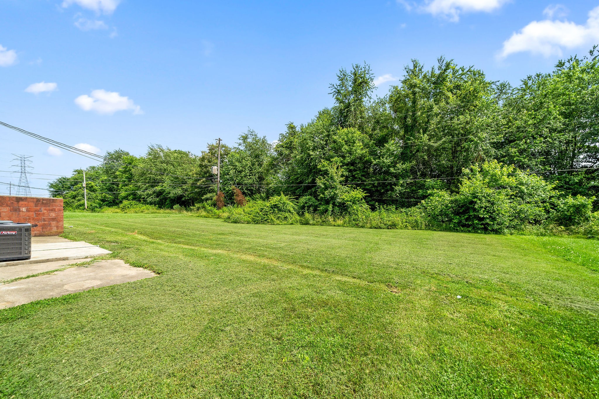 1231 State Line Road, Unit 46 Oak Grove, KY 42262 - Photo 2 of 12 a view of a grassy field with trees in the background