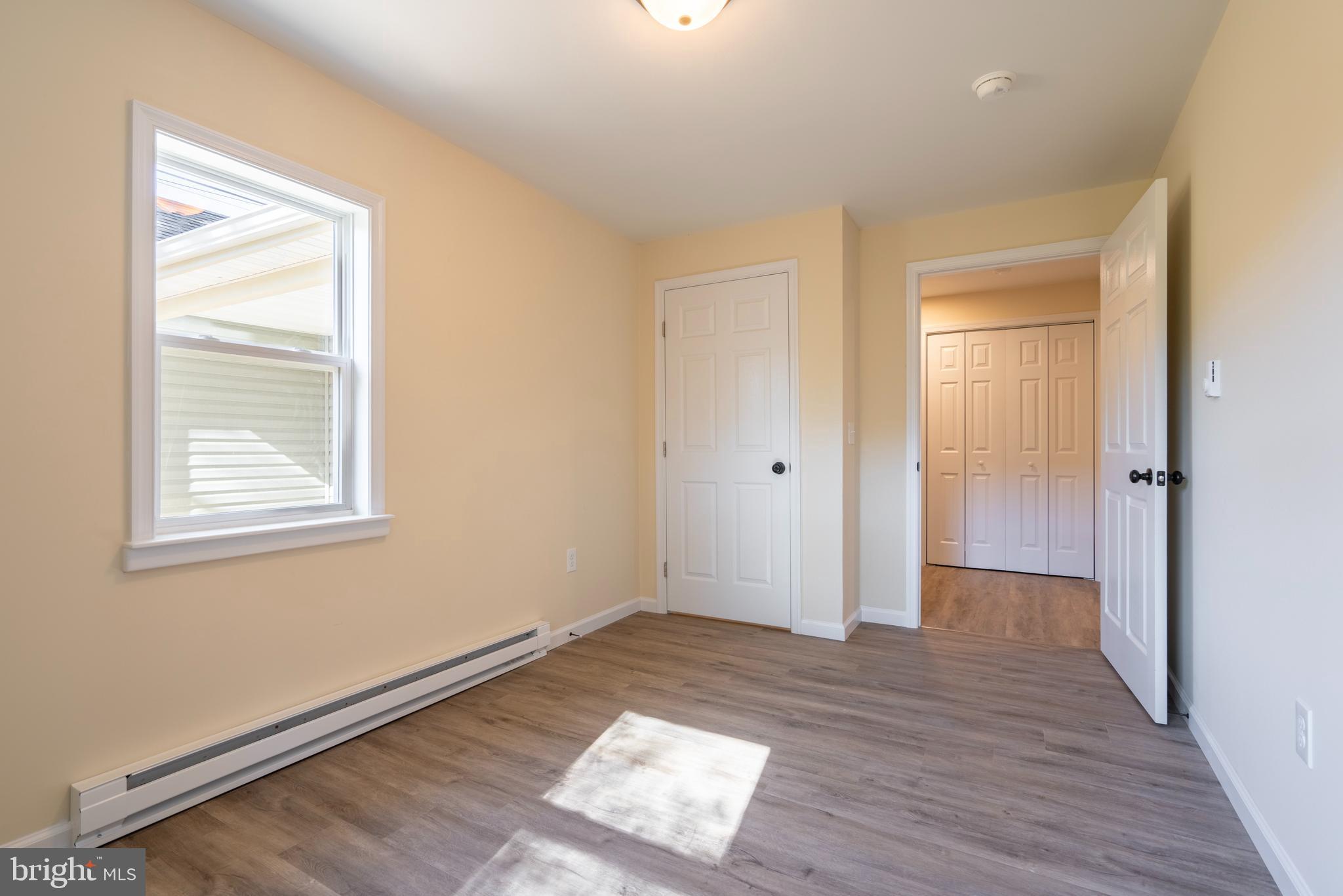 201 Hill Church Road Bechtelsville, PA 19505 - Photo 11 of 28 a view of an empty room with wooden floor and a window