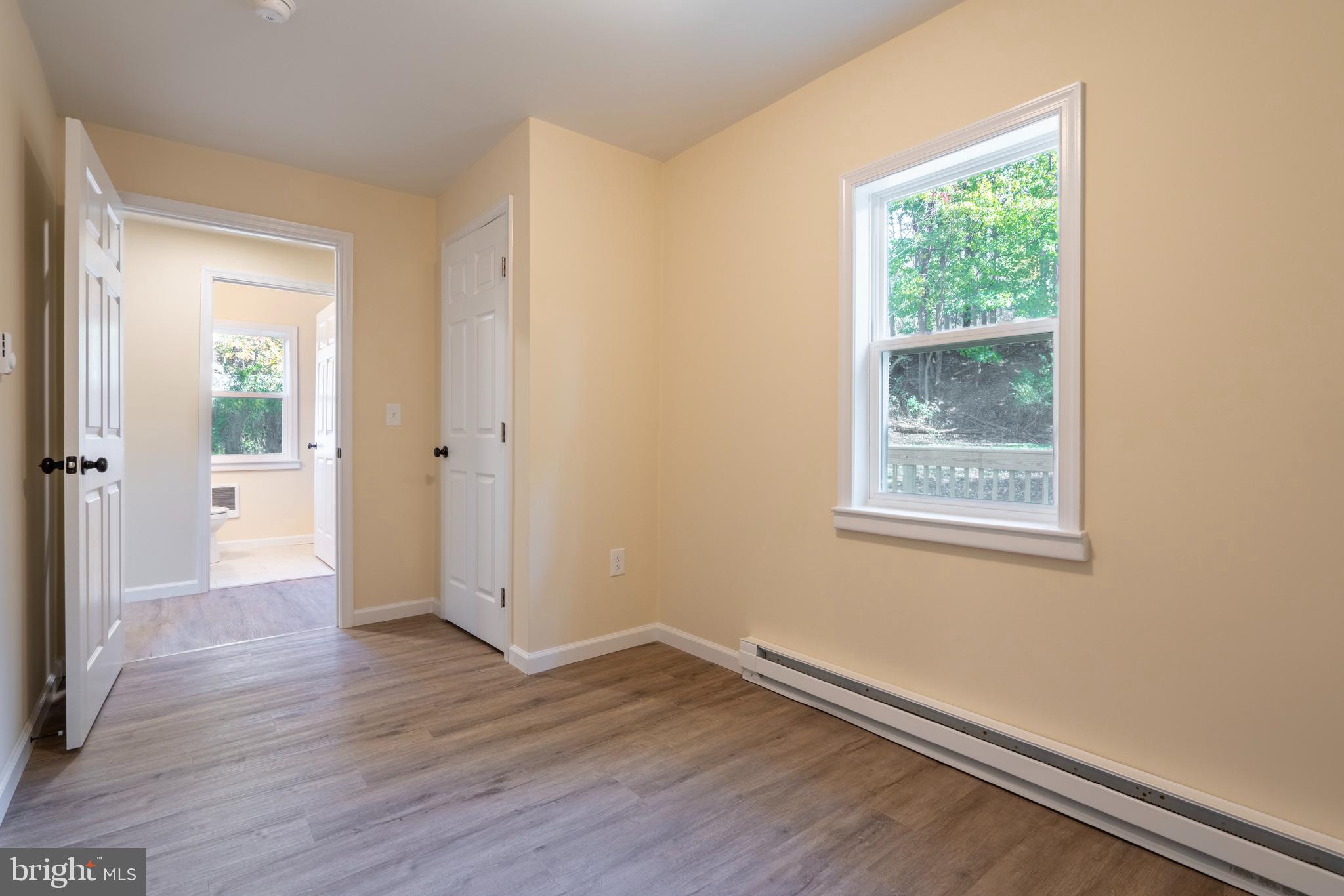 201 Hill Church Road Bechtelsville, PA 19505 - Photo 13 of 28 an empty room with wooden floor and a window