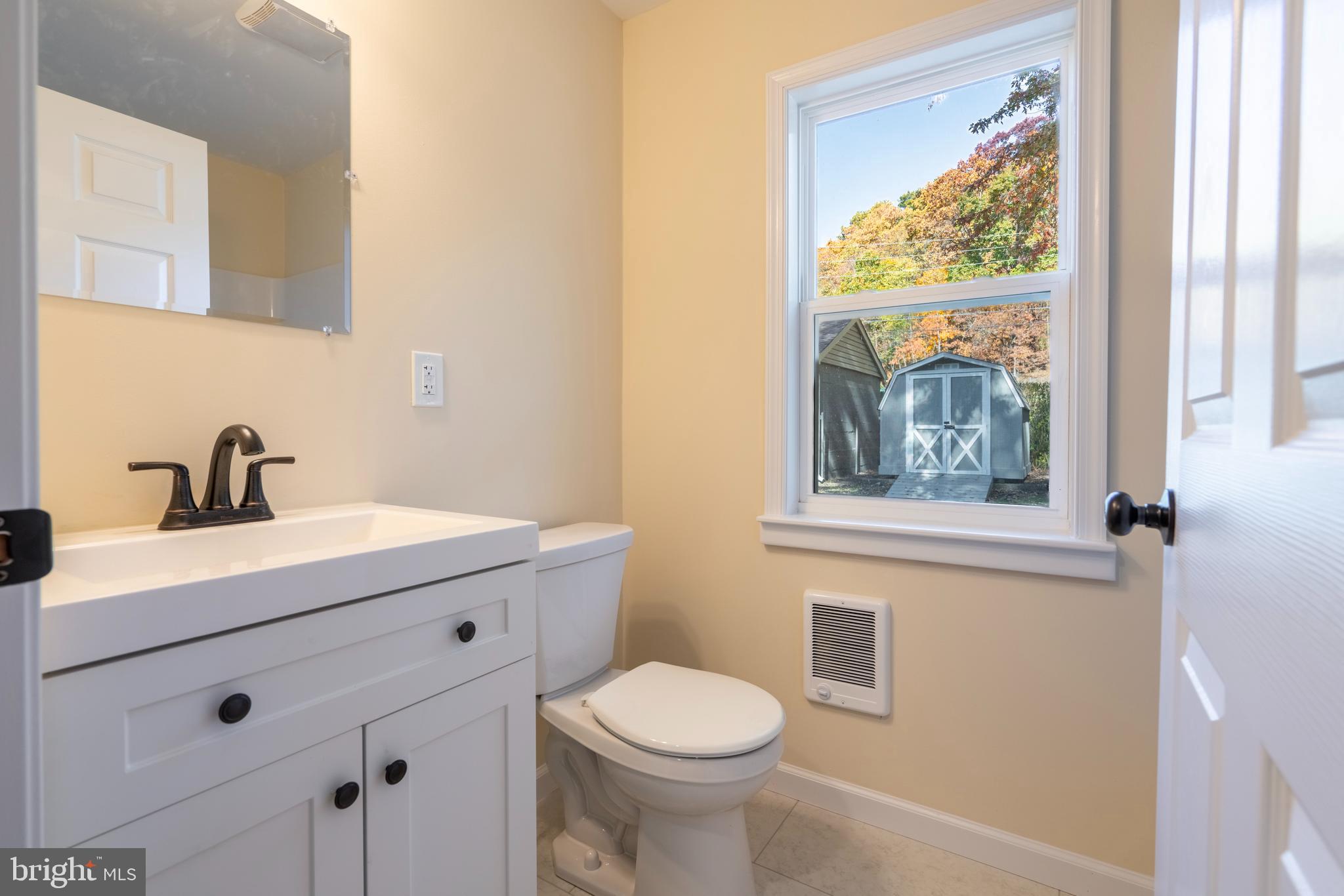 201 Hill Church Road Bechtelsville, PA 19505 - Photo 14 of 28 a bathroom with a toilet a sink and mirror