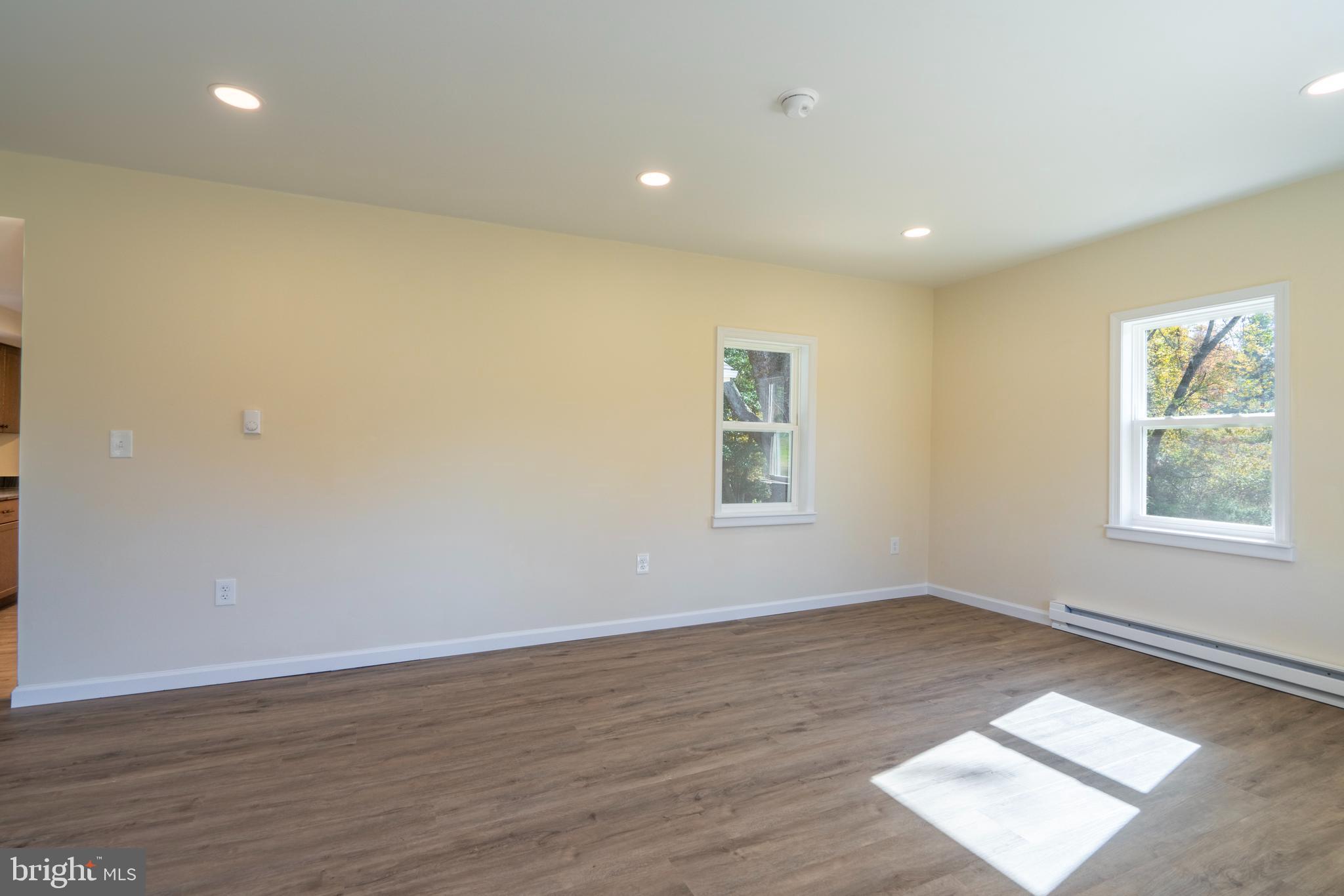 201 Hill Church Road Bechtelsville, PA 19505 - Photo 3 of 28 a view of an empty room with wooden floor and a window