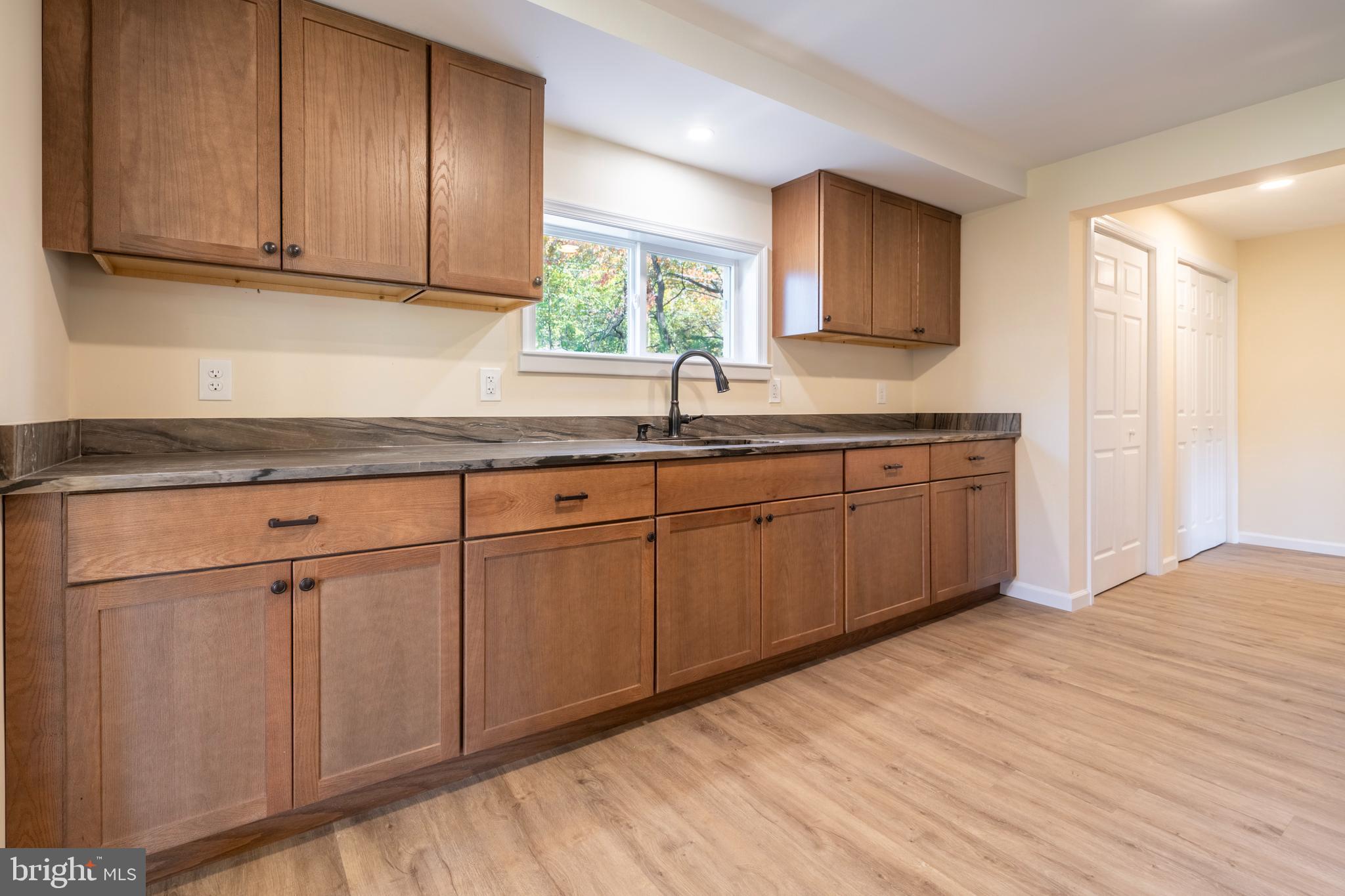 201 Hill Church Road Bechtelsville, PA 19505 - Photo 7 of 28 a kitchen with stainless steel appliances granite countertop a sink and cabinets with wooden floor