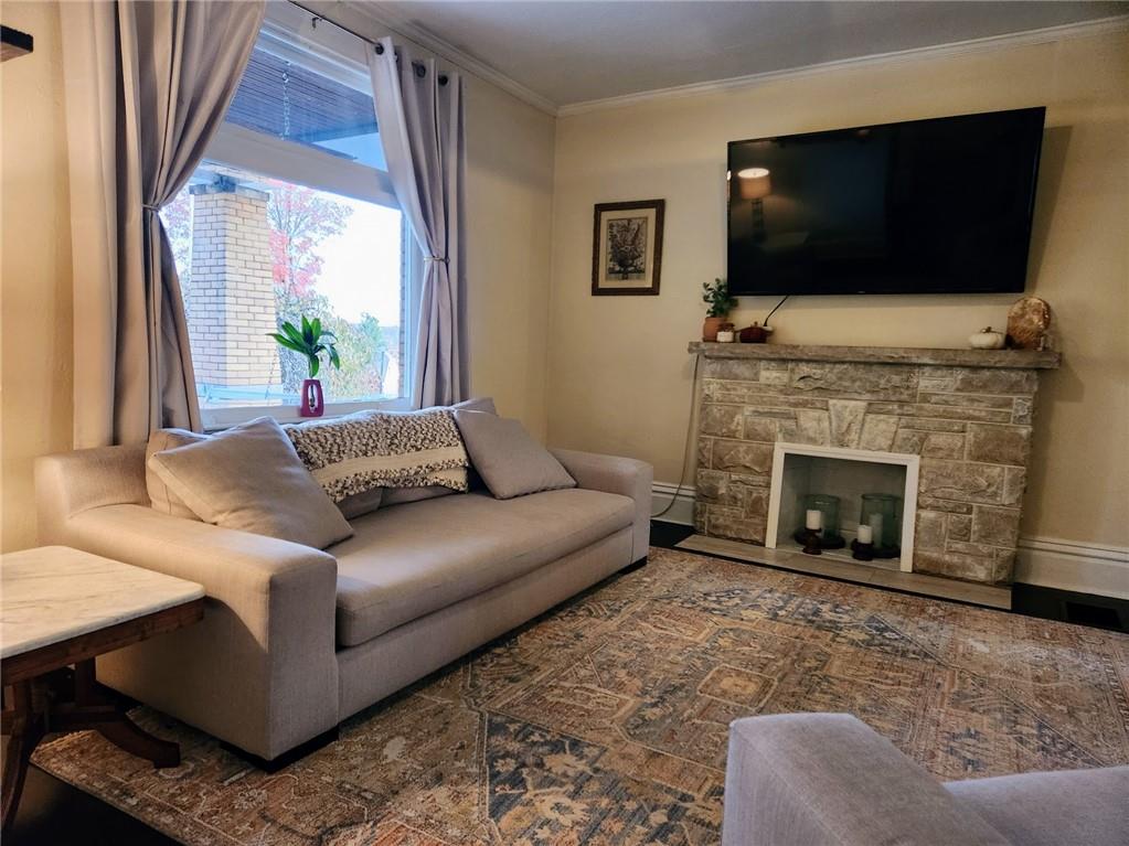 614 3rd Street Butler, PA 16001 - Photo 17 of 43 a living room with furniture a flat screen tv and a fireplace