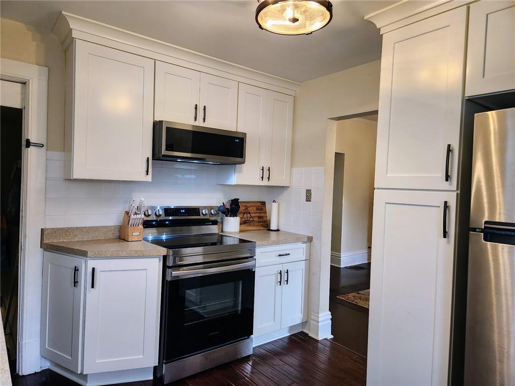 614 3rd Street Butler, PA 16001 - Photo 8 of 43 a kitchen with stainless steel appliances a stove a refrigerator and a microwave