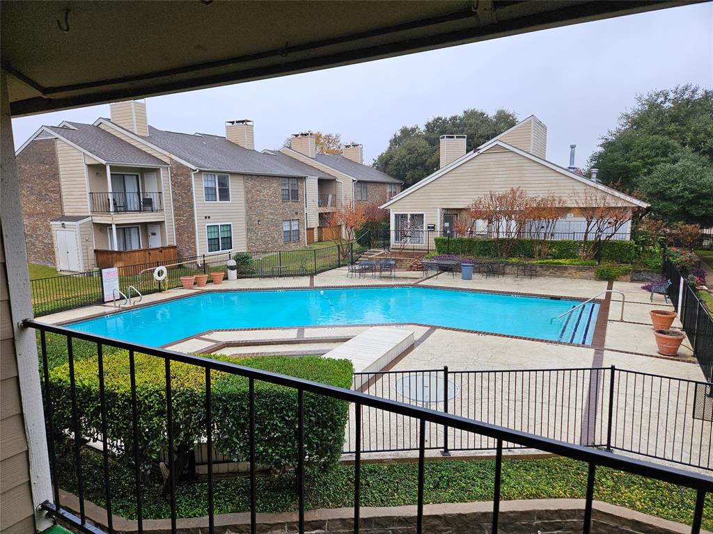a view of swimming pool with outdoor seating and yard