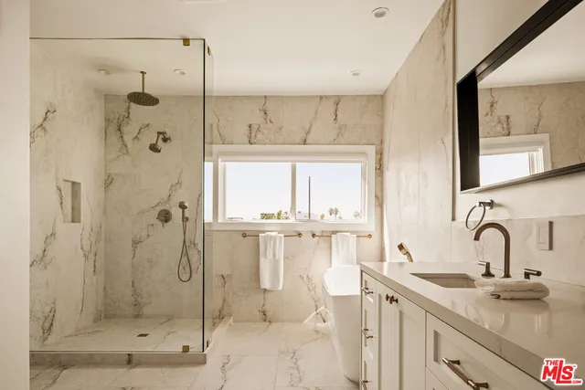 a bathroom with a shower sink and mirror