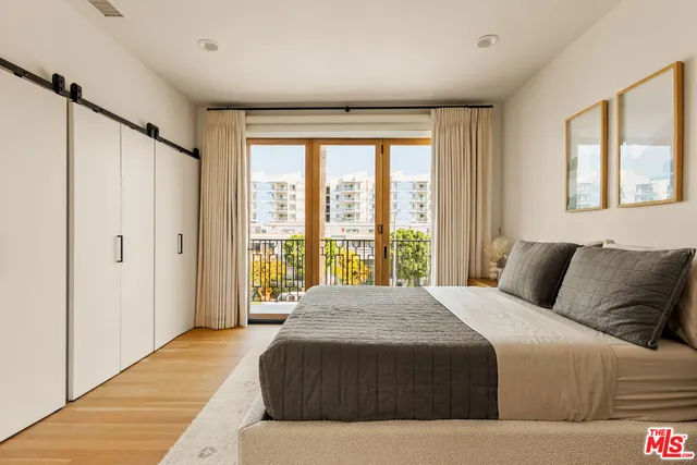 a bedroom with a large bed and a large window