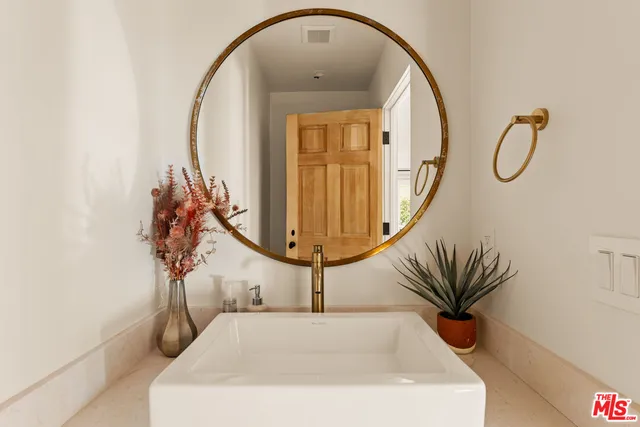 a bathroom with a sink a mirror and a shower