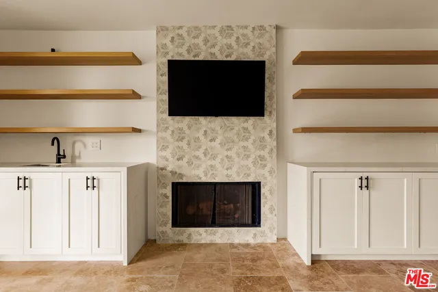 a living room with a fireplace and a flat screen tv