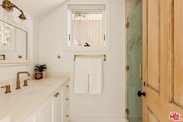 a bathroom with a sink vanity and a mirror