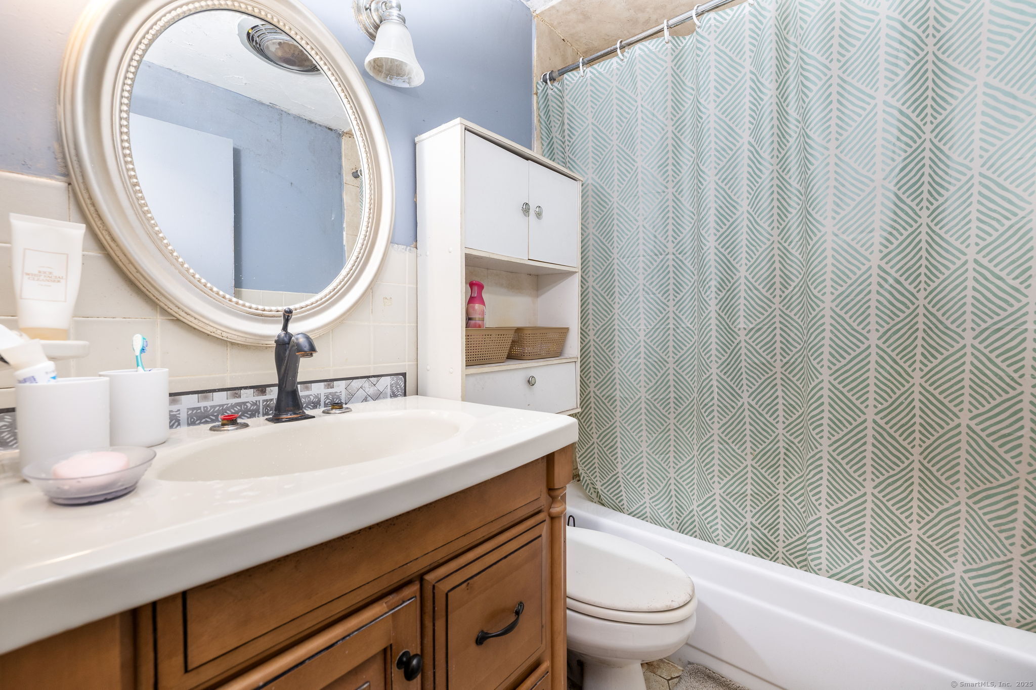 173 Timber Trail Wethersfield, CT 06109 - Photo 16 of 18 a bathroom with a sink a toilet and a mirror