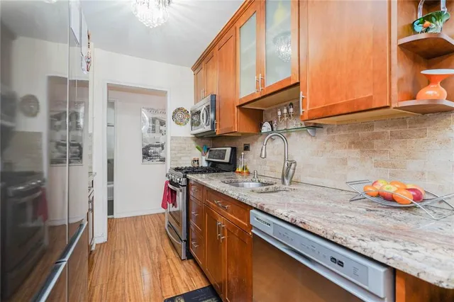 a kitchen with stainless steel appliances granite countertop a sink and cabinets