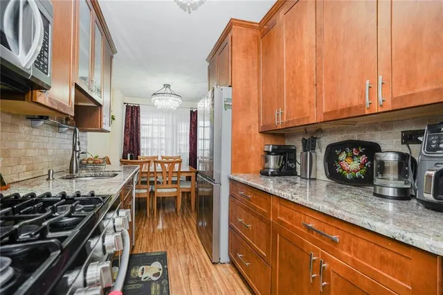 a kitchen with granite countertop lots of counter top space and stainless steel appliances
