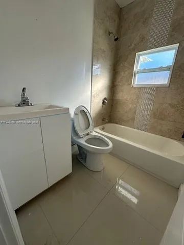 a bathroom with a toilet a sink and bathtub