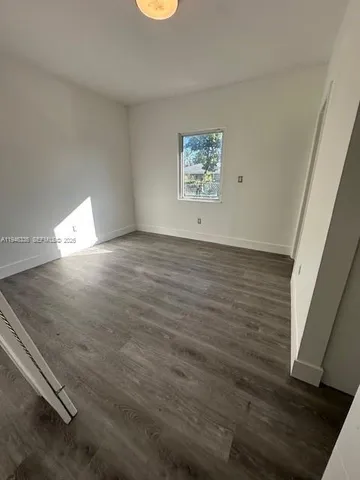 a view of an empty room and wooden floor