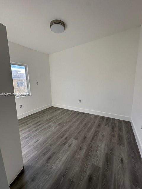 113 Northeast 75th Street, Unit FRONT Miami, FL 33138 - Photo 6 of 9 an empty room with wooden floor and windows