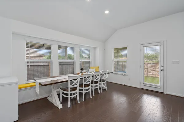 a view of a dining room with furniture and wooden floor