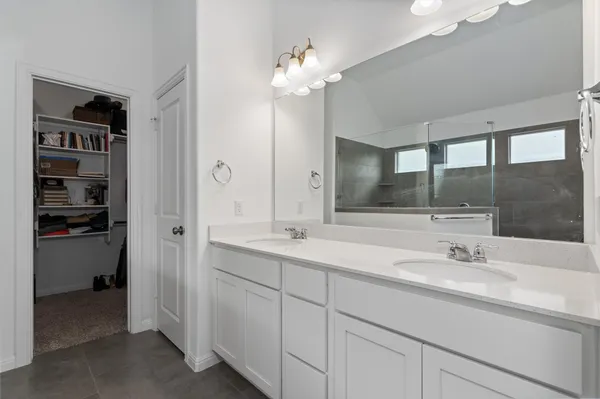 a bathroom with a sink double vanity and a mirror