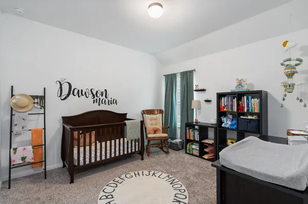 a bedroom with a bunk bed table and a bookshelf