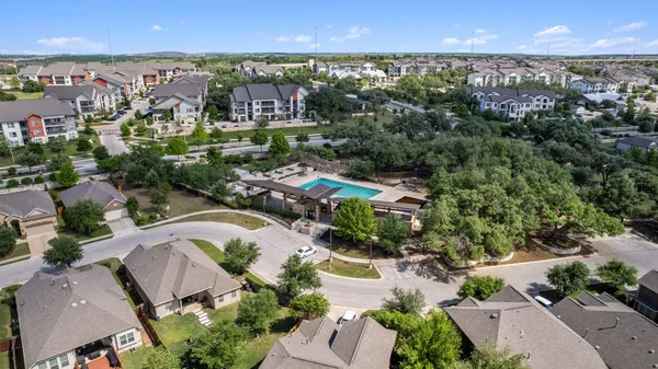 an aerial view of residential houses with outdoor space