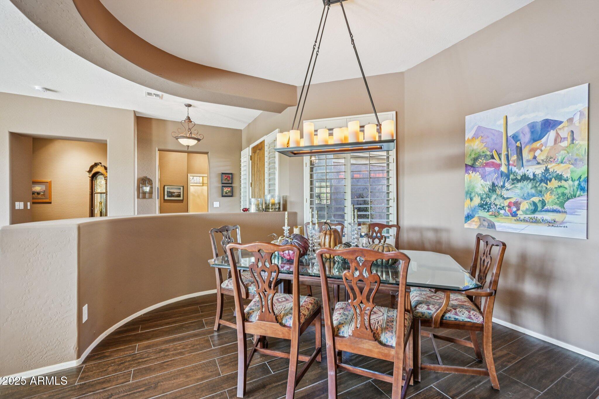 41725 North Golf Crest Road Anthem, AZ 85086 - Photo 12 of 60 a view of a dining room with furniture window and wooden floor