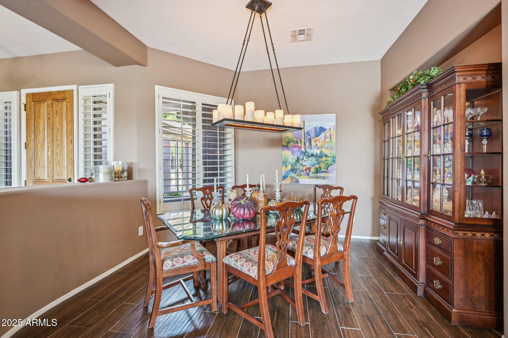 41725 North Golf Crest Road Anthem, AZ 85086 - Photo 13 of 60 a dining room with furniture window and wooden floor