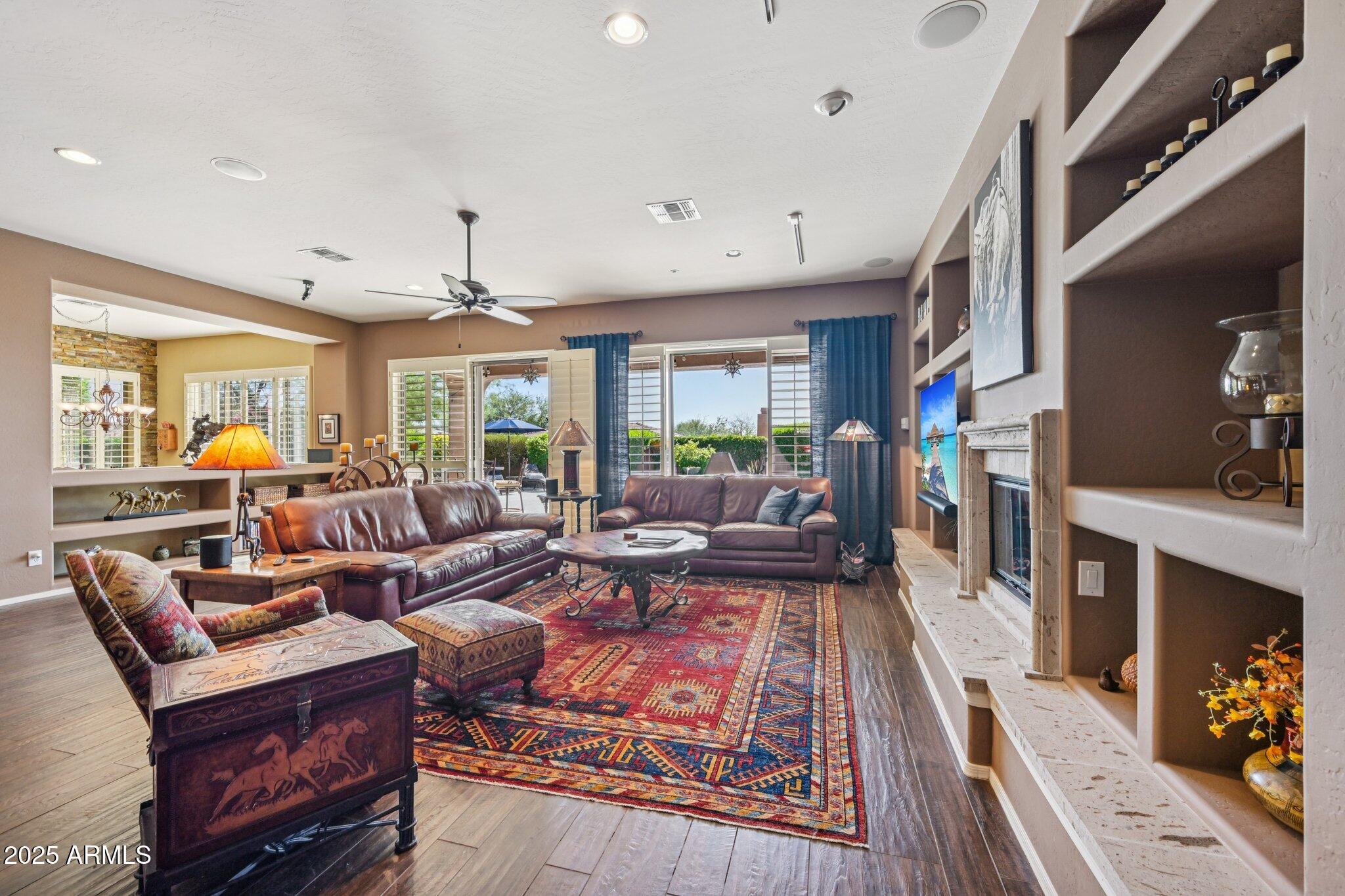 41725 North Golf Crest Road Anthem, AZ 85086 - Photo 15 of 60 a living room with fireplace furniture and a large window