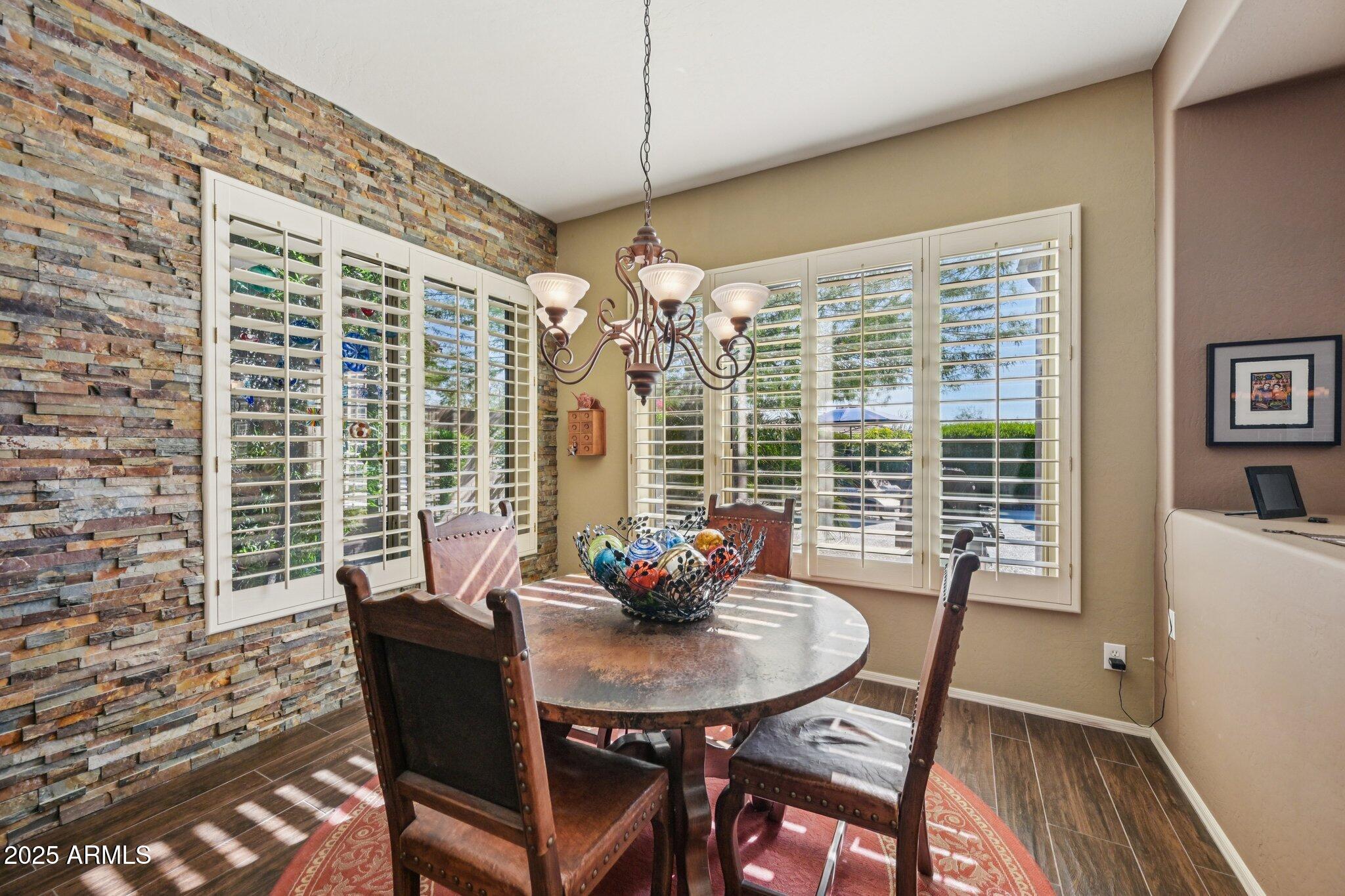 41725 North Golf Crest Road Anthem, AZ 85086 - Photo 19 of 60 a view of a dining room with furniture window and outside view