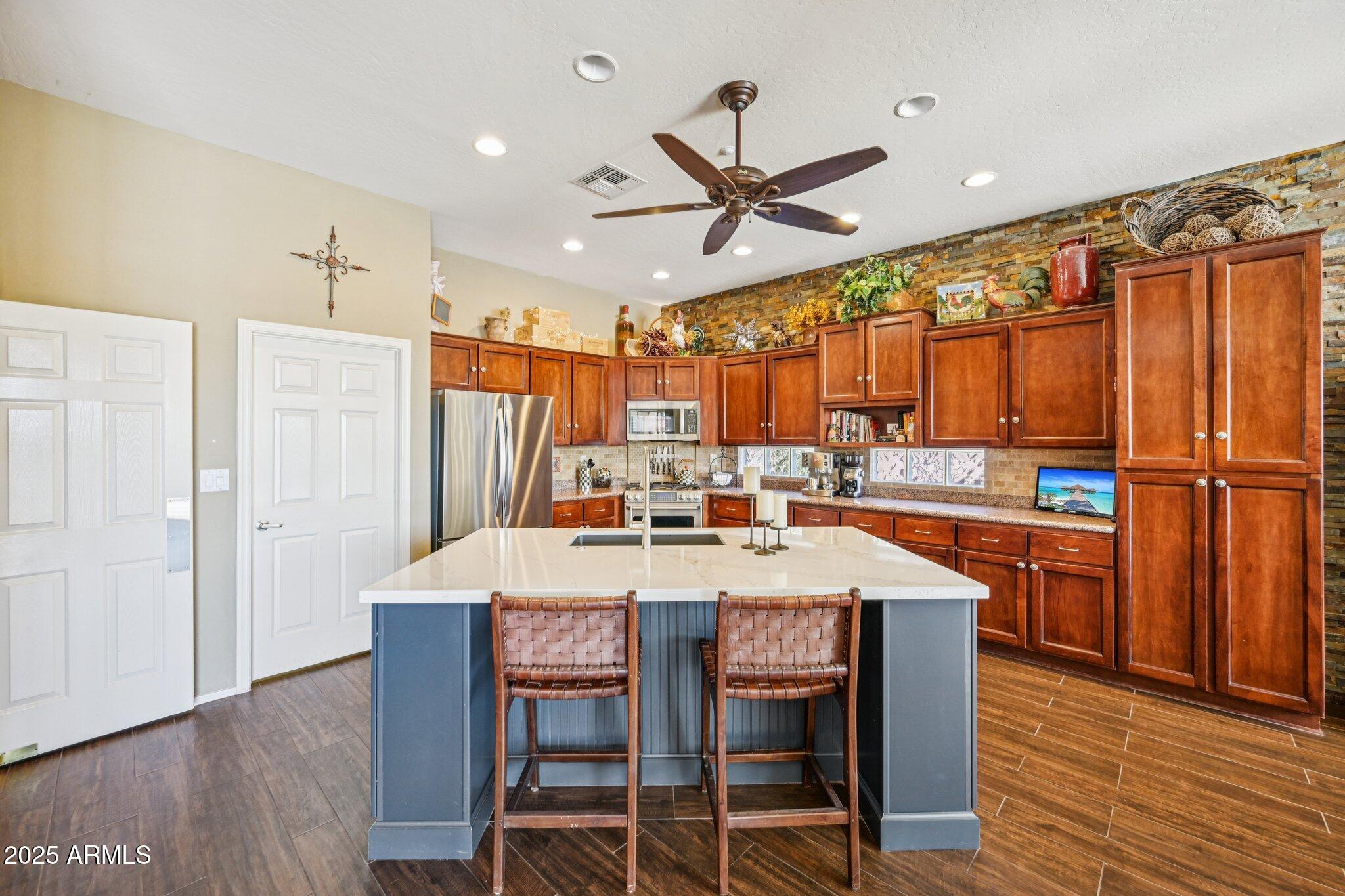 41725 North Golf Crest Road Anthem, AZ 85086 - Photo 21 of 60 a view of a dining room with furniture window and wooden floor