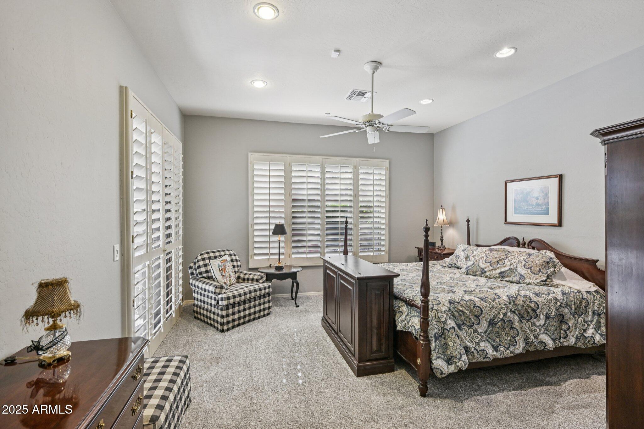 41725 North Golf Crest Road Anthem, AZ 85086 - Photo 25 of 60 a bedroom with a bed and a chandelier