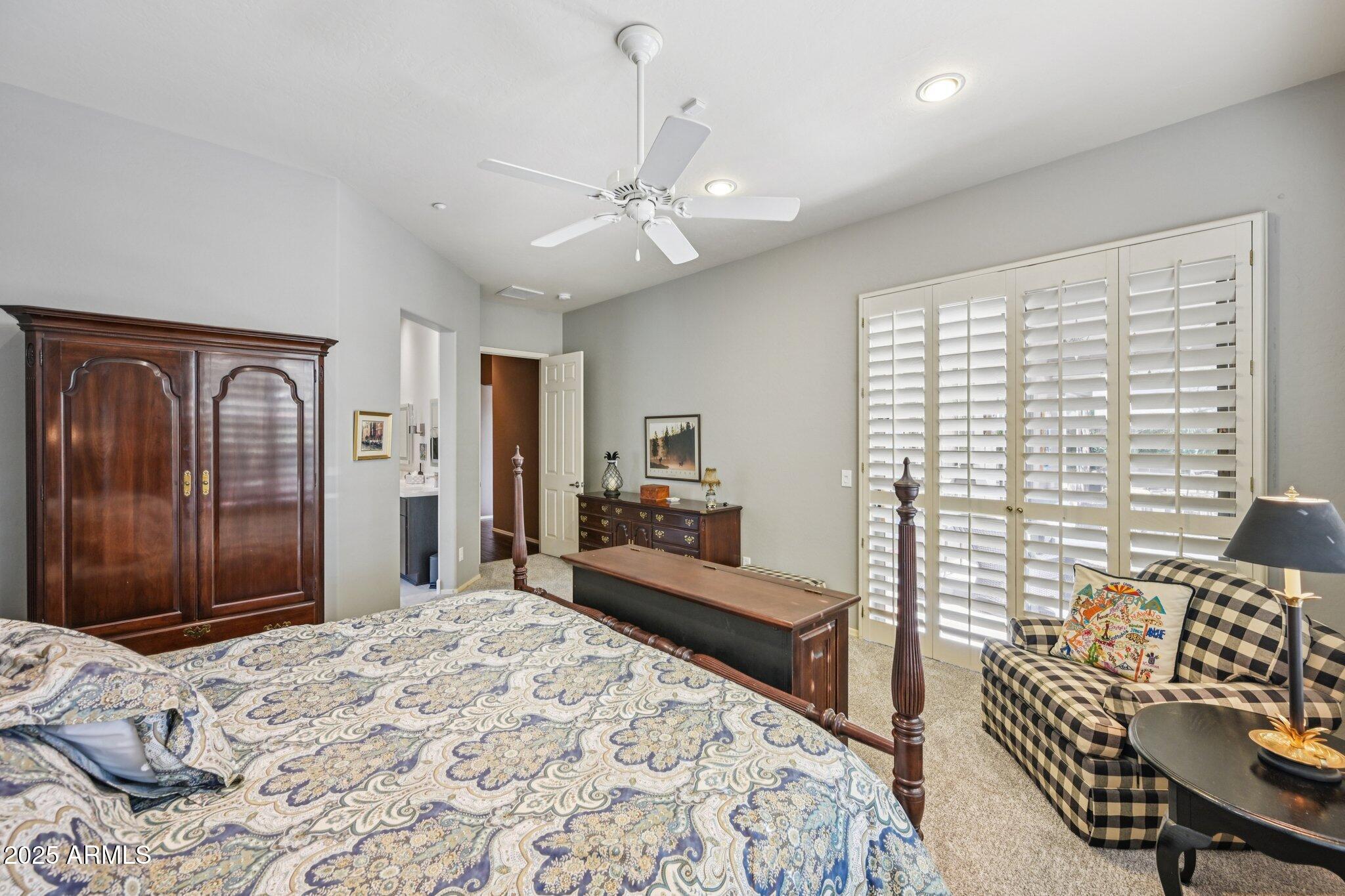 41725 North Golf Crest Road Anthem, AZ 85086 - Photo 27 of 60 a bedroom with a bed and wooden floor