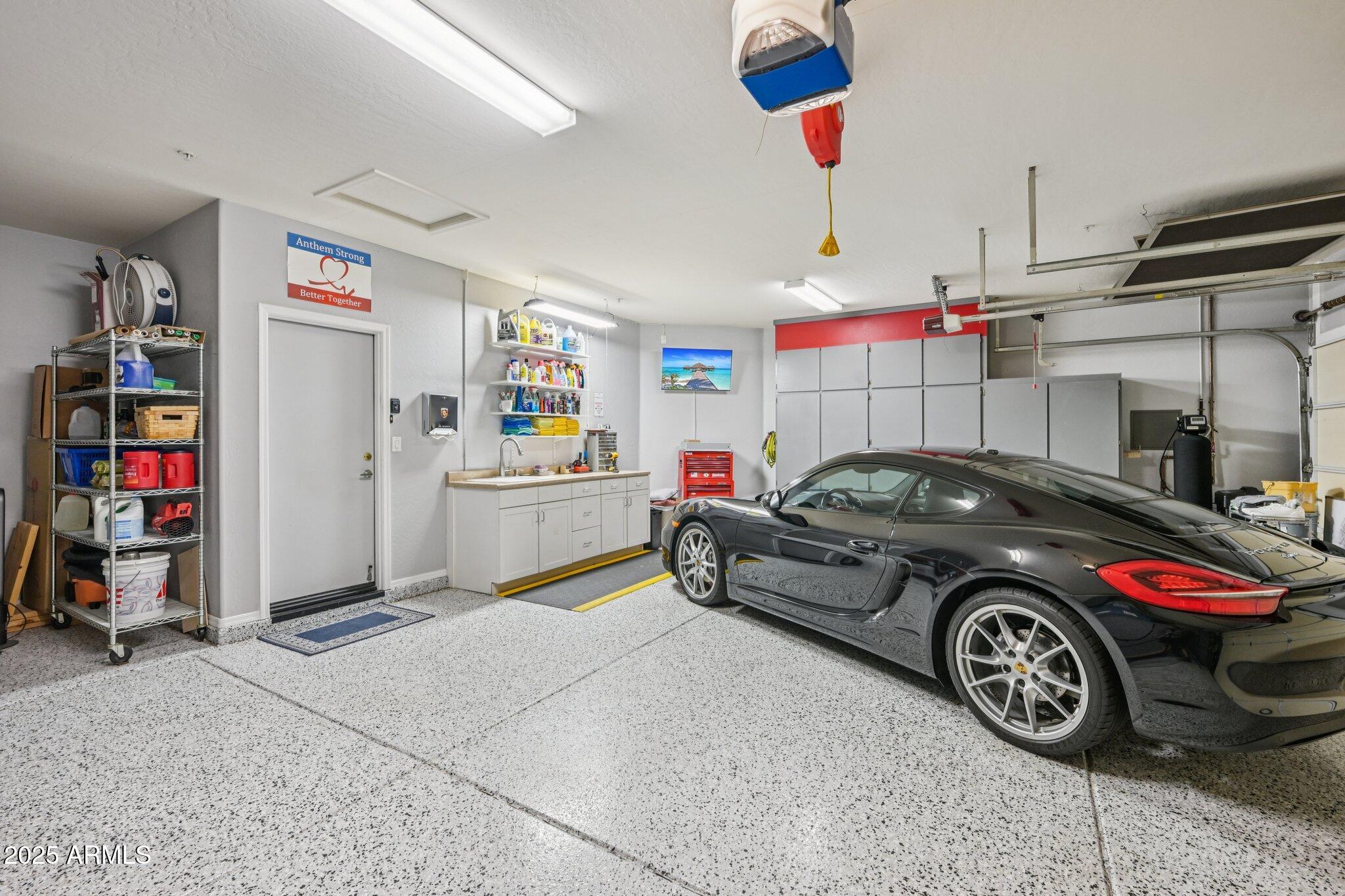 41725 North Golf Crest Road Anthem, AZ 85086 - Photo 39 of 60 a car is parked in a garage