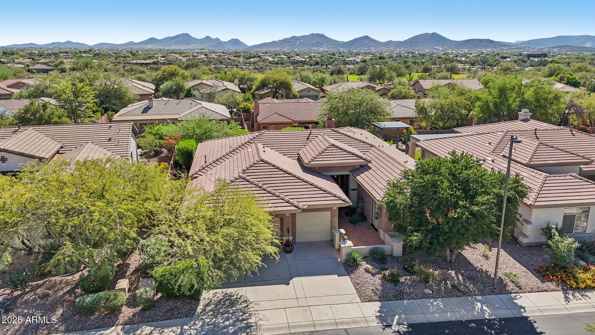 41725 North Golf Crest Road Anthem, AZ 85086 - Photo 49 of 60 an aerial view of a house with a mountain