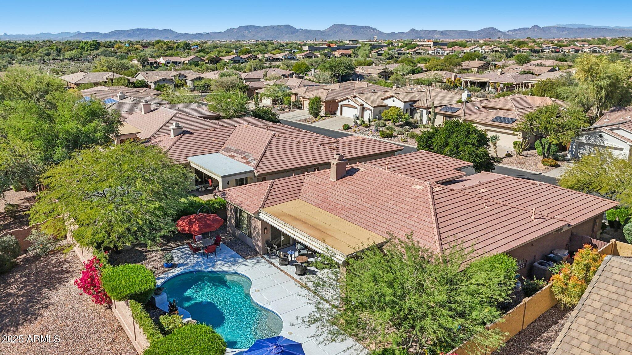 41725 North Golf Crest Road Anthem, AZ 85086 - Photo 55 of 60 an aerial view of a house with a garden