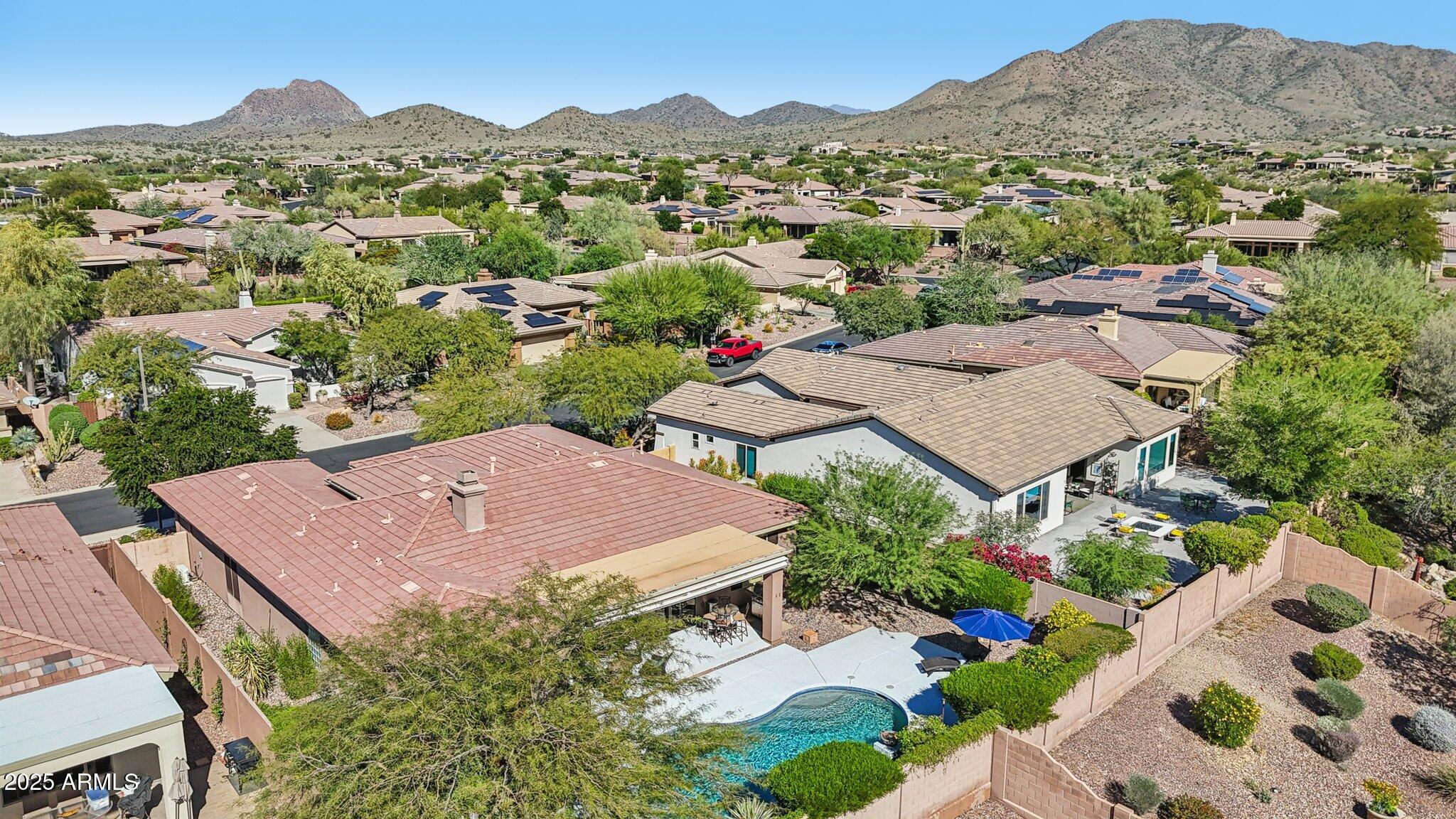 41725 North Golf Crest Road Anthem, AZ 85086 - Photo 57 of 60 an aerial view of a house with a garden