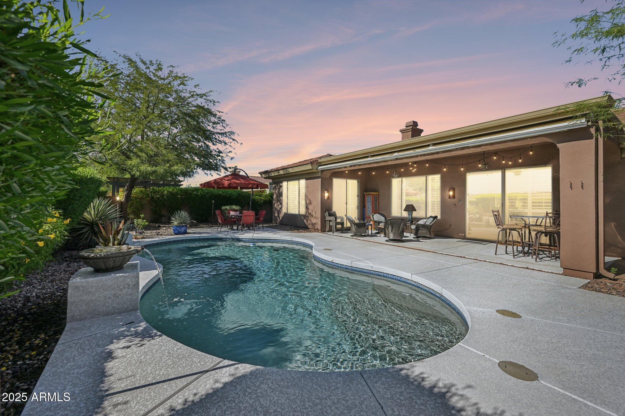 41725 North Golf Crest Road Anthem, AZ 85086 - Photo 4 of 60 a swimming pool with outdoor seating and yard