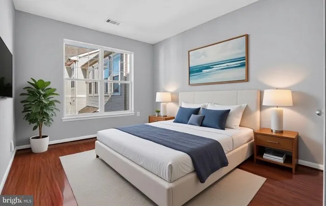 a spacious bedroom with a bed and a large window