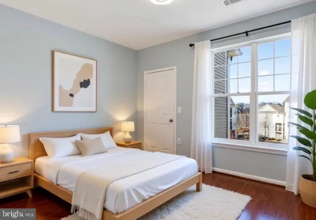 a bedroom with a bed and a large window